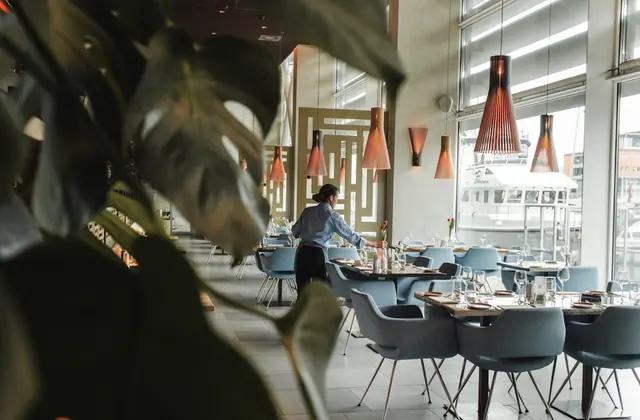 A waiter preparing tables in an elegant restaurant